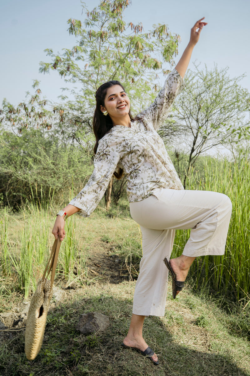 Female model wearing an olive green botanical casual wear peplum top by 22twelve