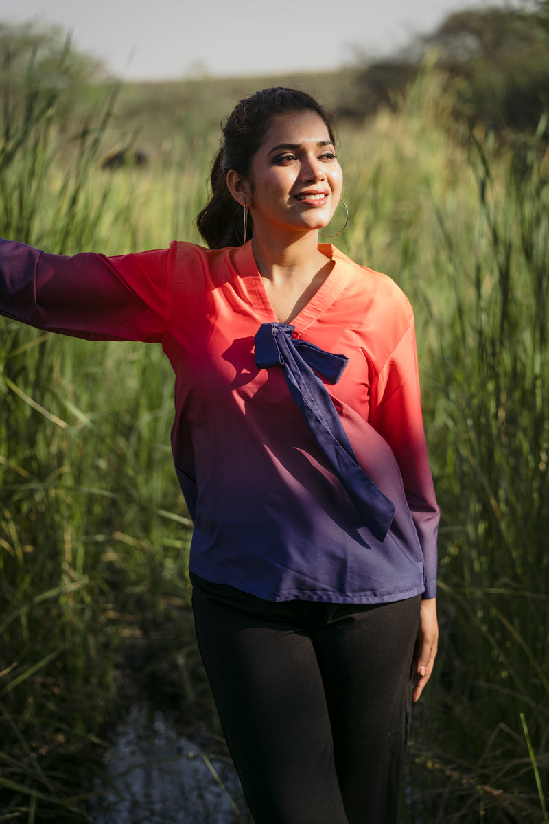 Female model wearing an orange-blue firefly ombre casual wear tie top by 22twelve